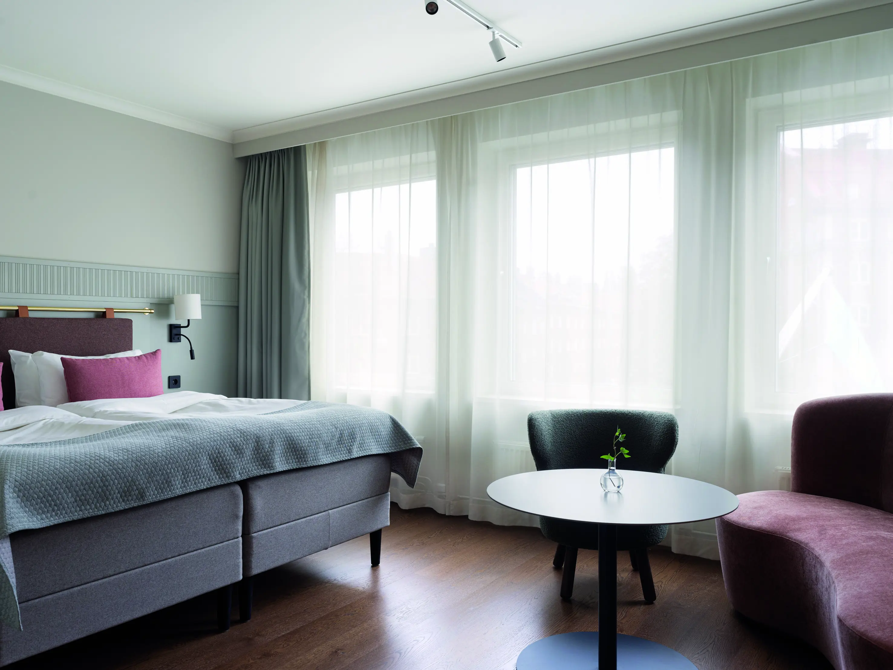 A double bed in a large bright room