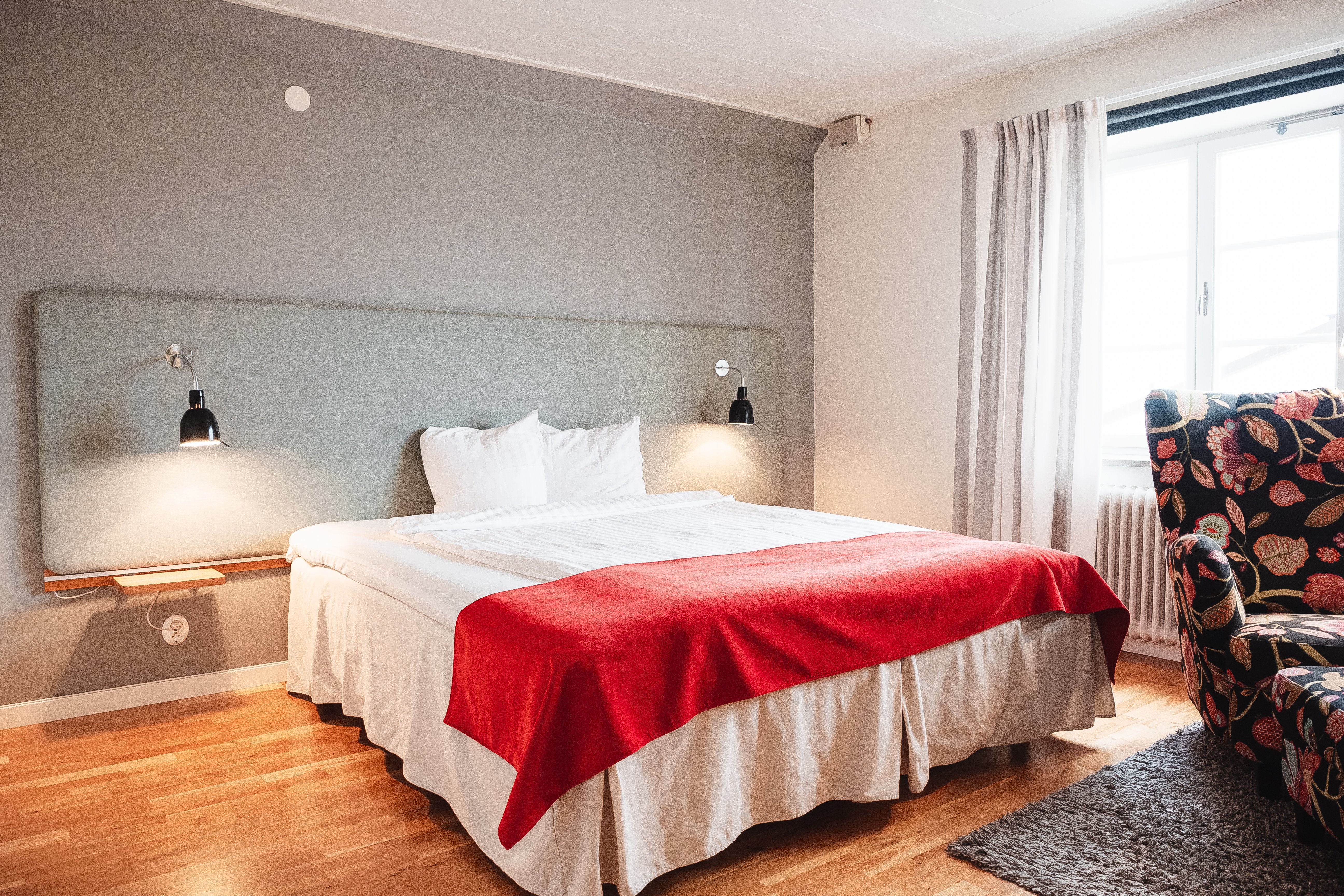 Cozy hotel room with bed, armchair and window