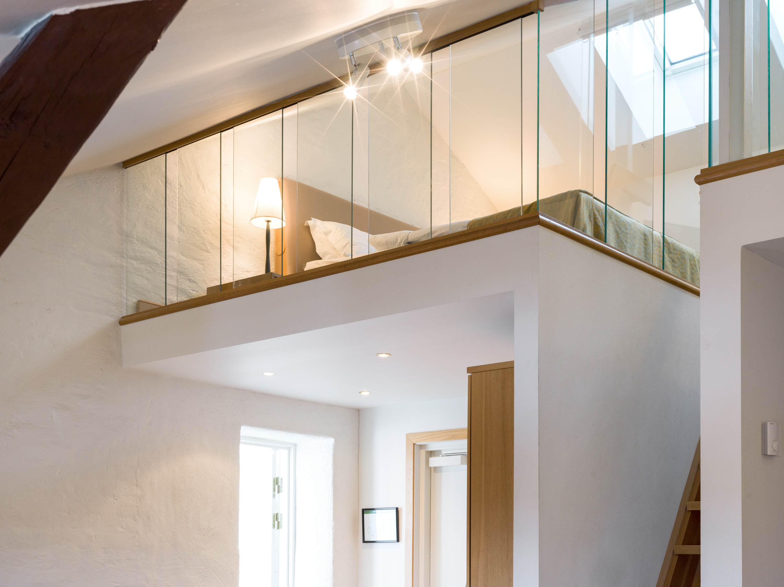 Bright suite with bed, sleeping loft and glass railing