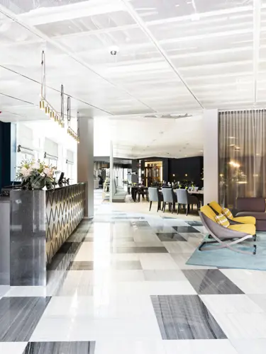 Bright hotel reception with lounge furniture