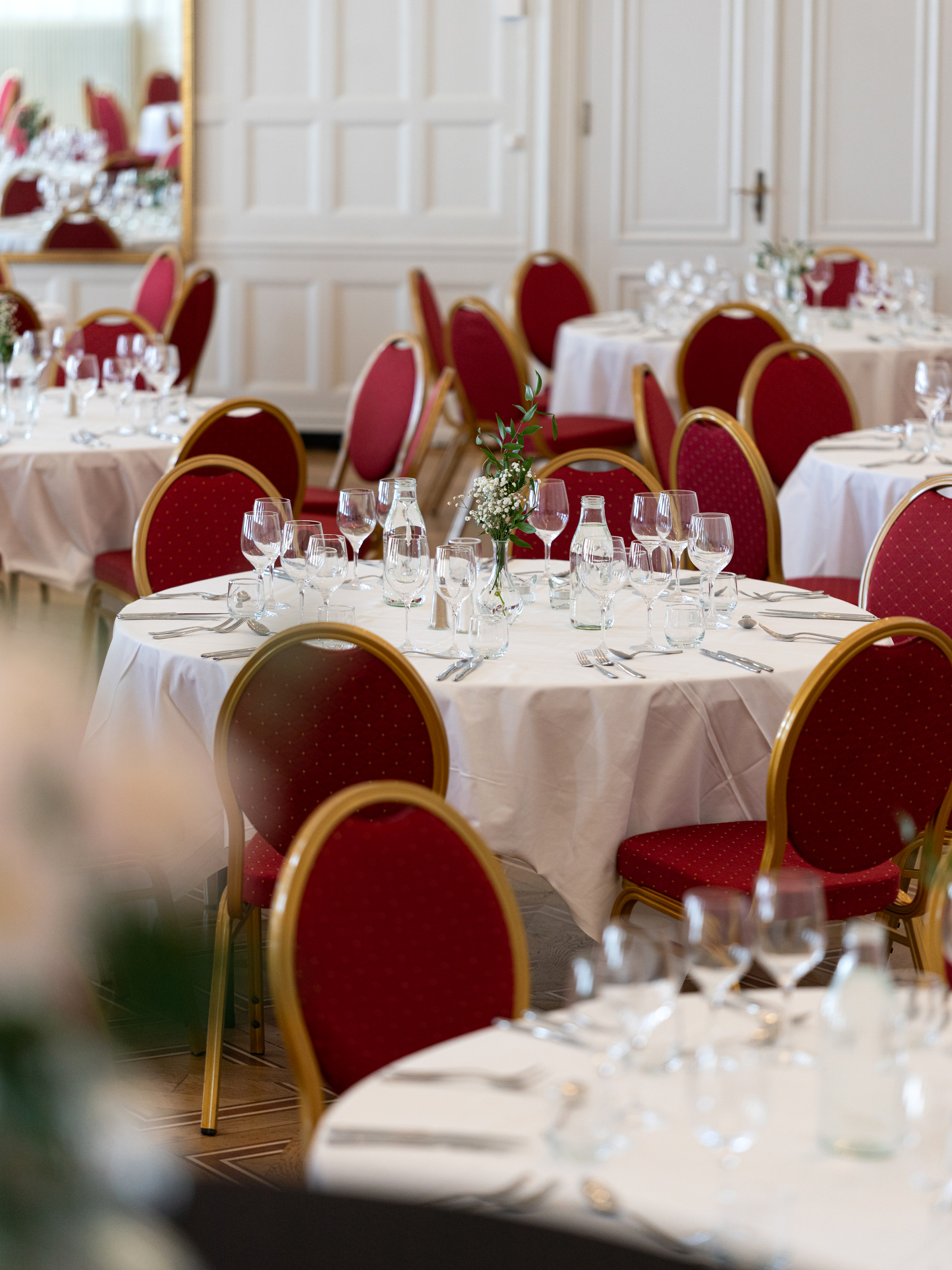 Table with white tablecloths in banquet hall