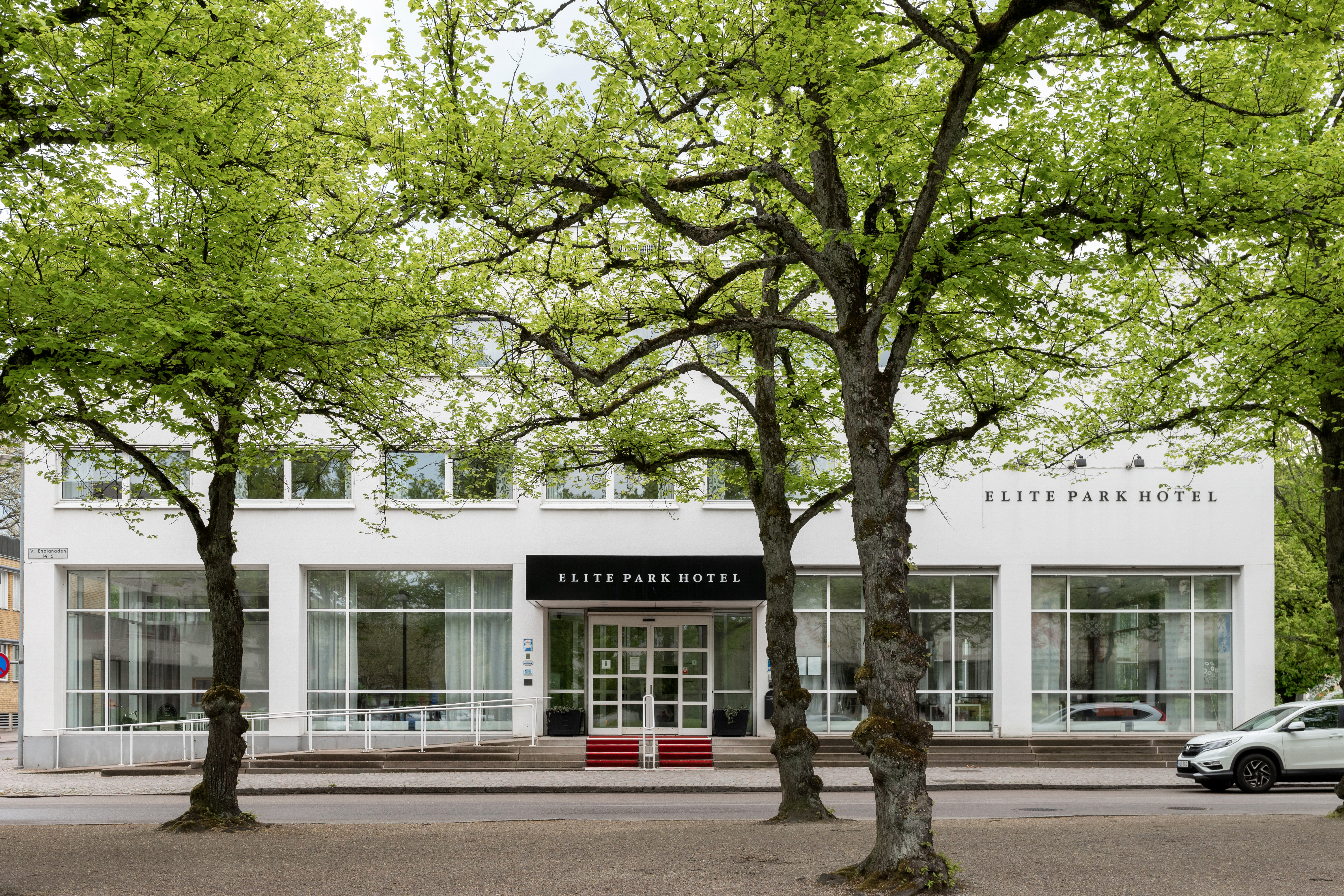 The entrance to the Elite Park Hotel with trees outside