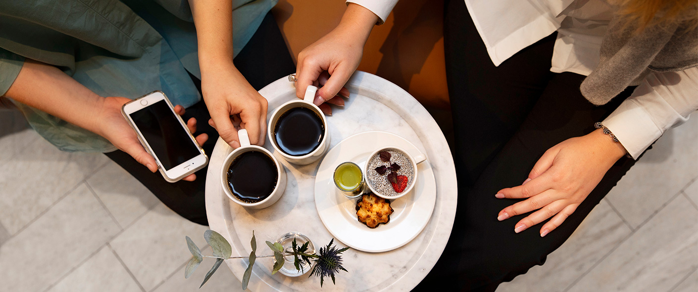 Two persons having coffe at a table