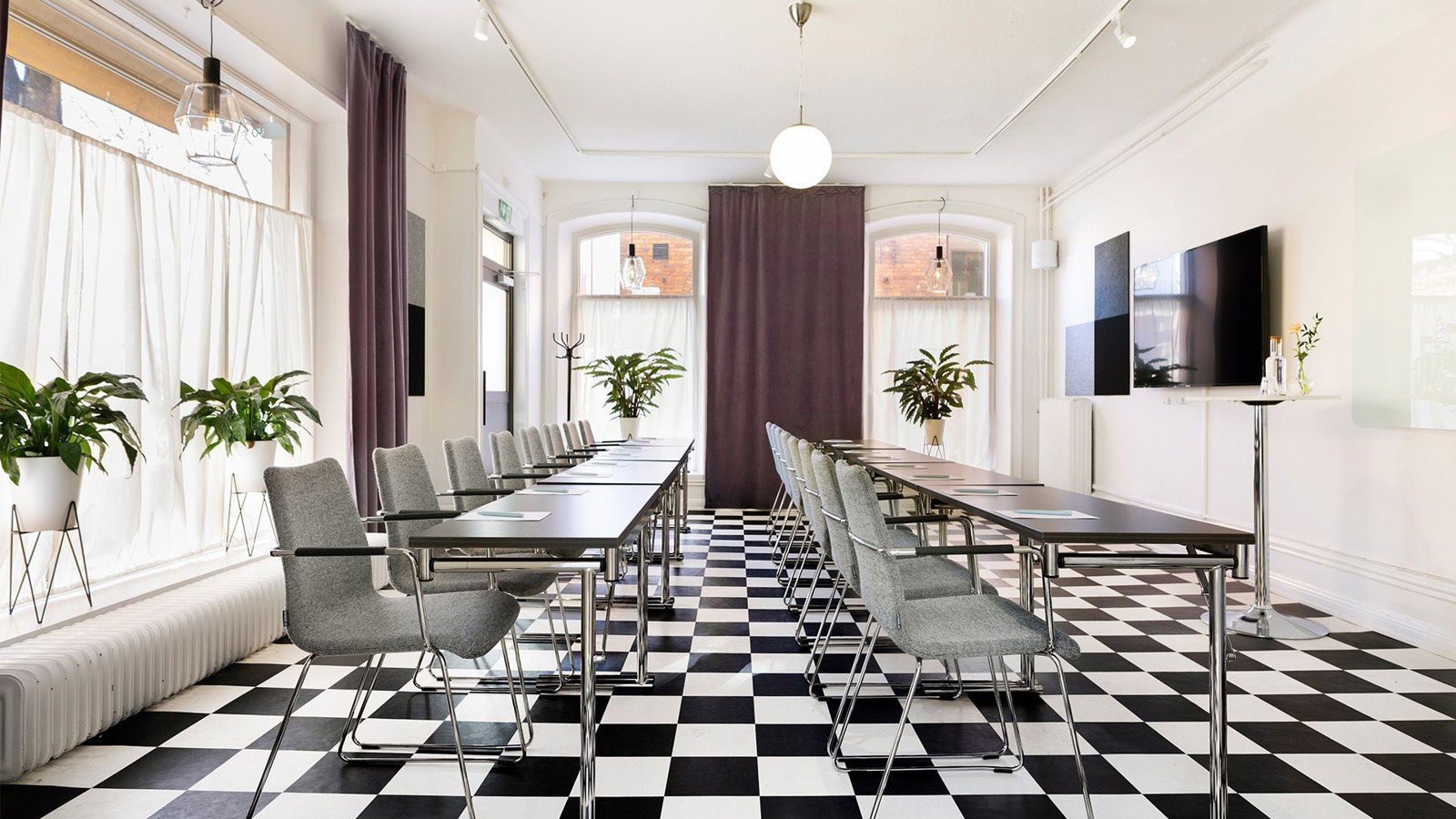 Conference room with checkerboard floor, chairs and large windows