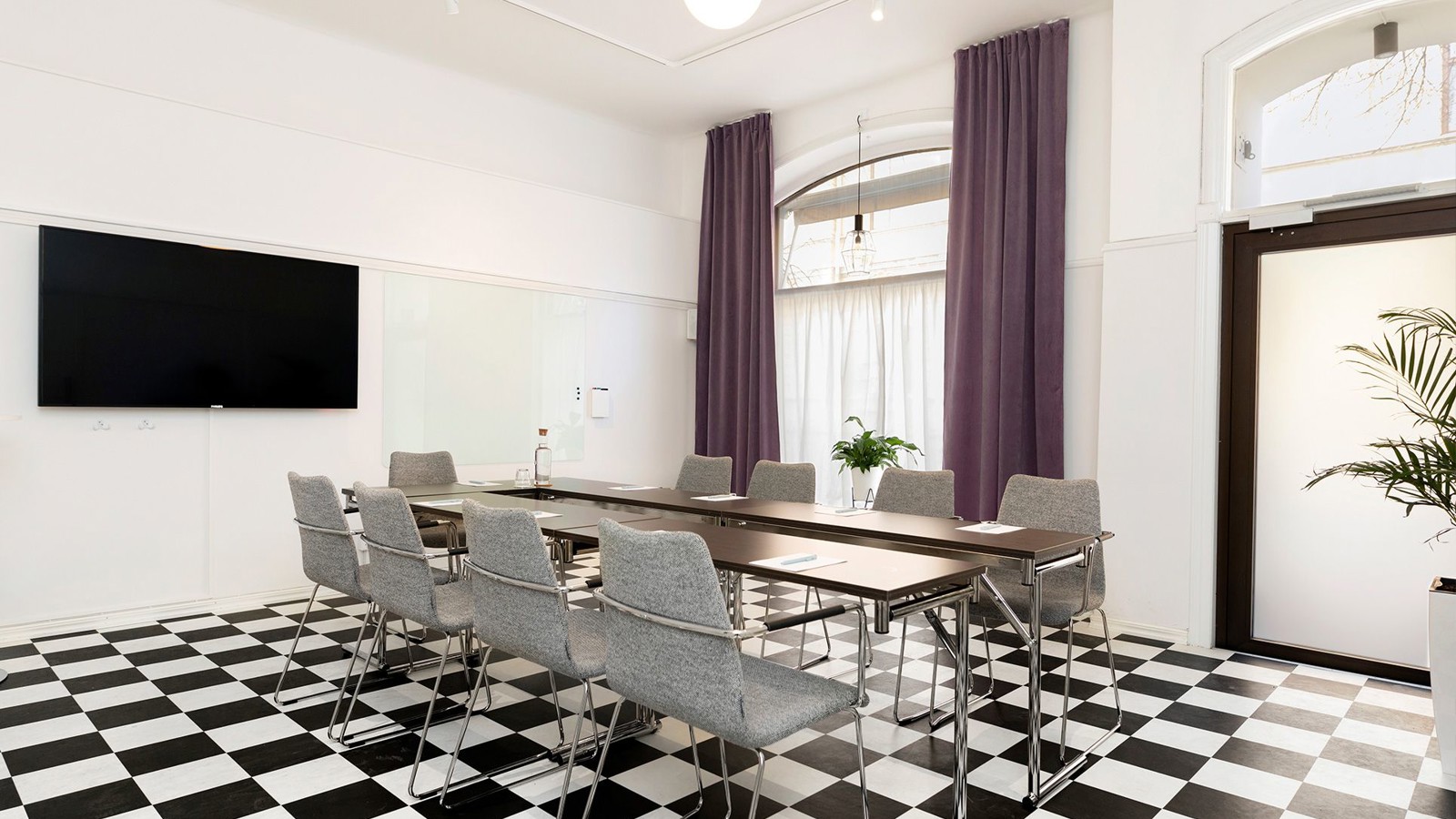 Conference room with checkerboard floor, table and chairs