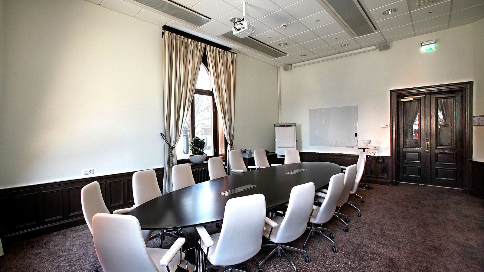 Conference with round table, large door and window