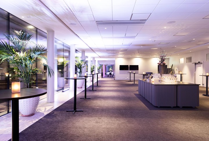 Glazed veranda with sofa and cozy lighting