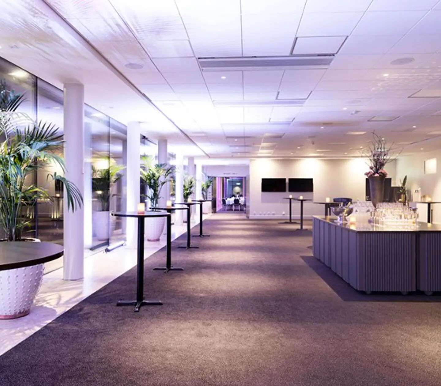 Inglasad veranda med soffa och mysig belysning