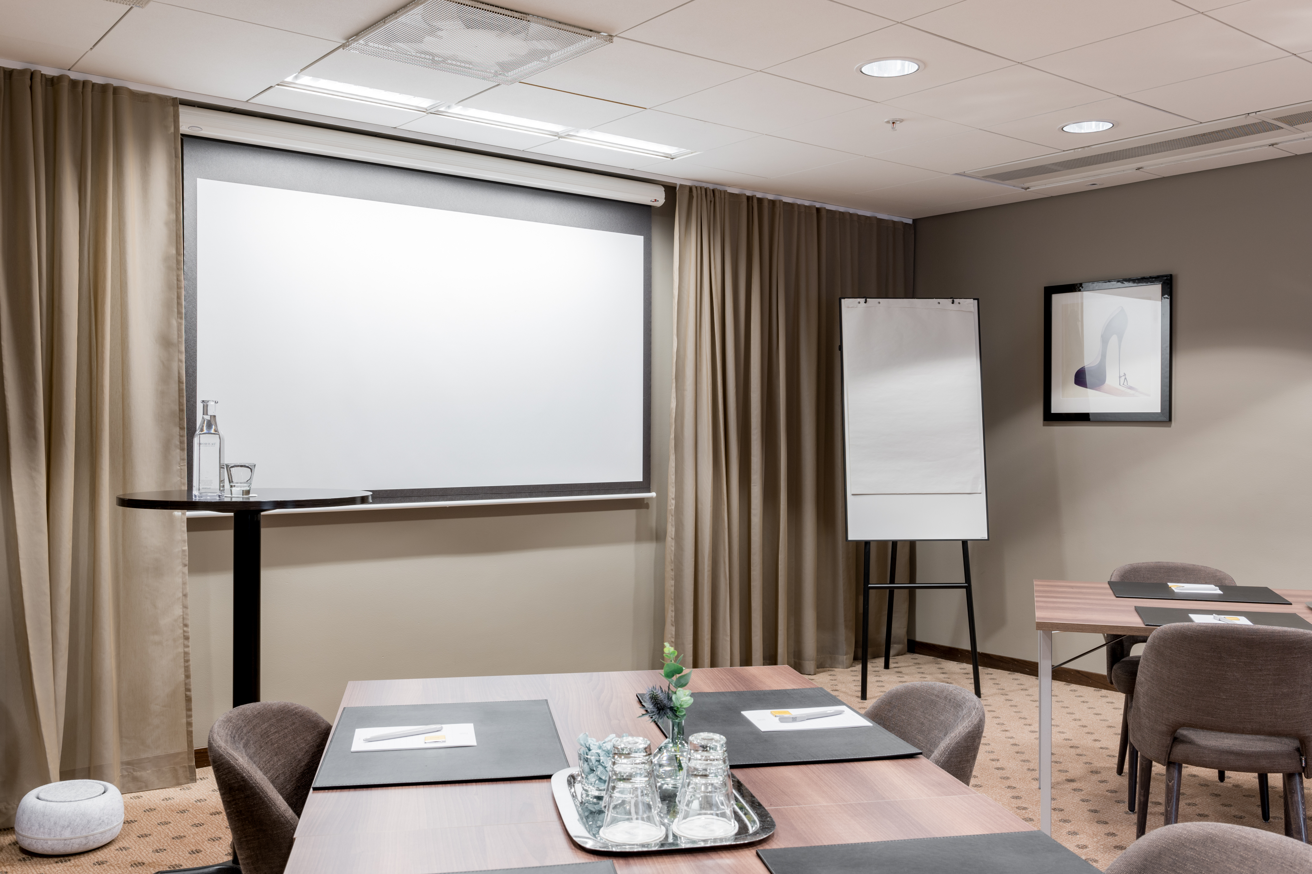 Nice conference room with tables, chairs, and a whiteboard