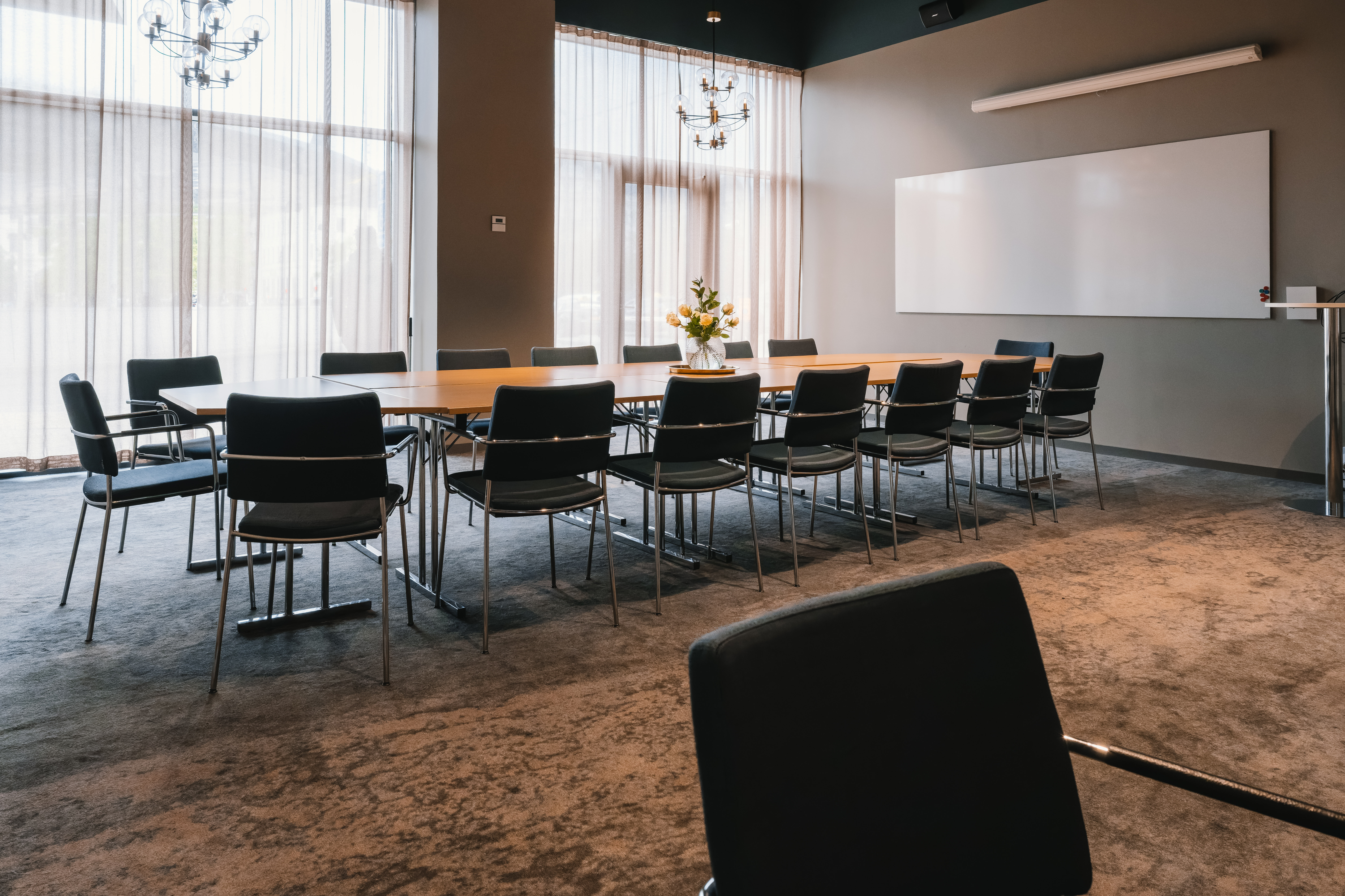 Conference room with a fruit bowl, computers, and sketch pads