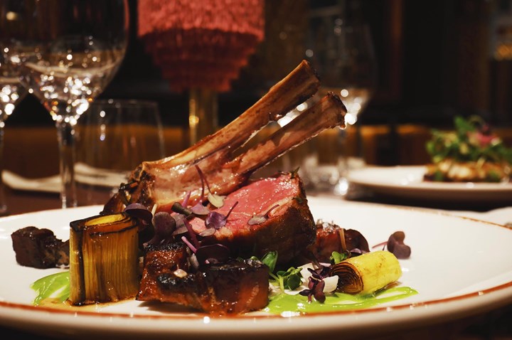 Served meat with accessories, on a white plate