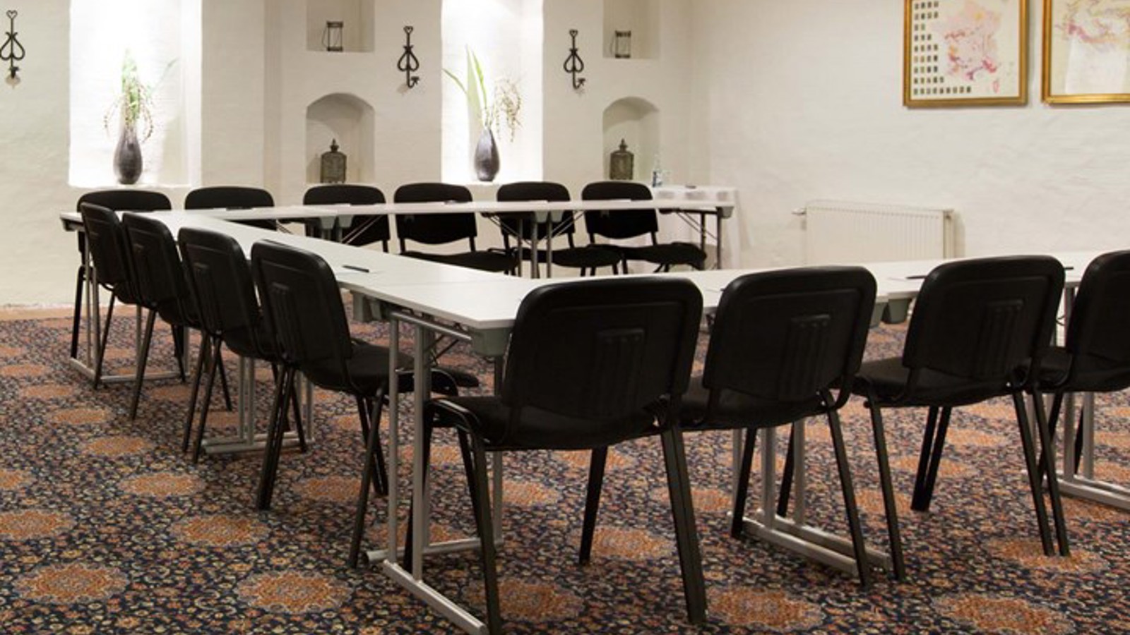 Conference room with u-shaped seating and patterned carpet