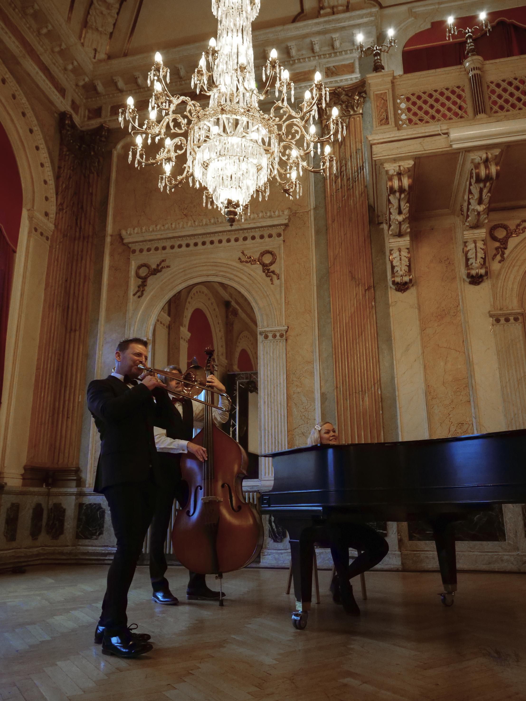 Close-up of an elegant crystal chandelier with gold detailing that reflects light.