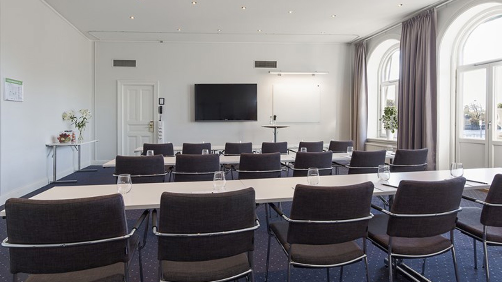 Conference room with crescent windows and a TV screen
