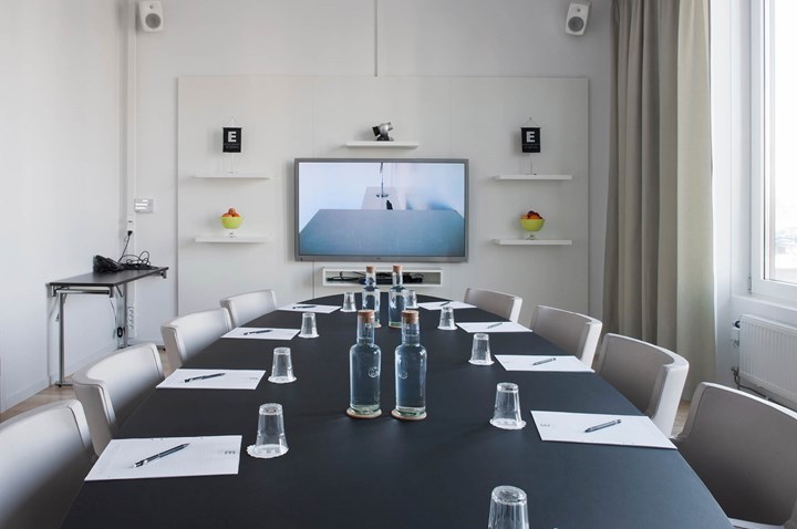 Boardroom with black table, white walls