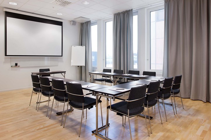 Conference room with u-shaped seating, a projector, large windows and wooden floor