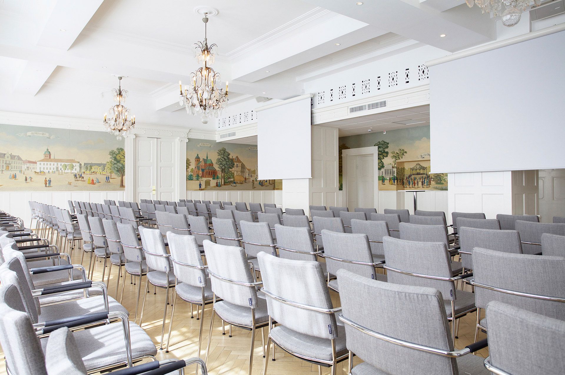 Large venue with lined up gray chairs
