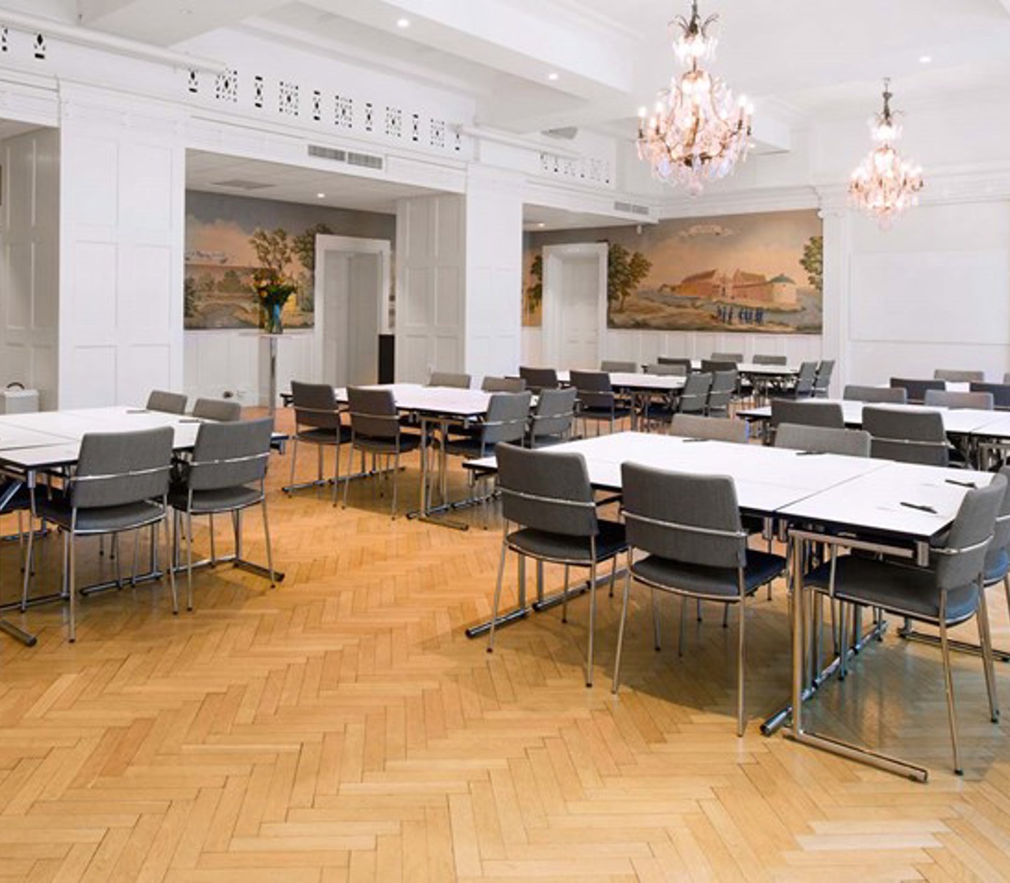 Conference room with crystal chandeliers on the ceiling prepared for meeting