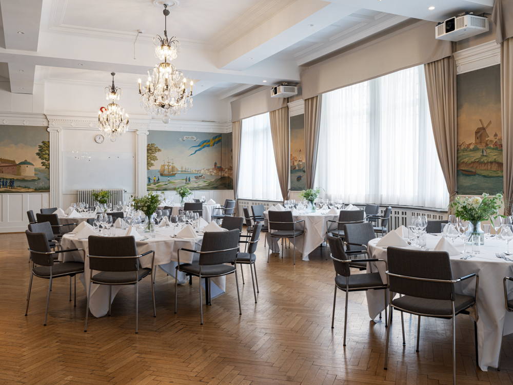 Conference room with crystal chandeliers on the ceiling prepared for meeting