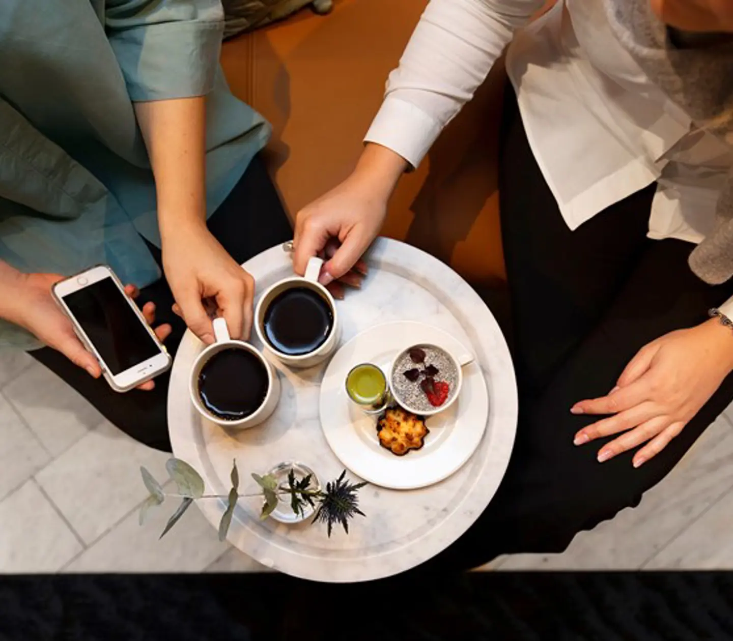 Close-up of two people having coffee