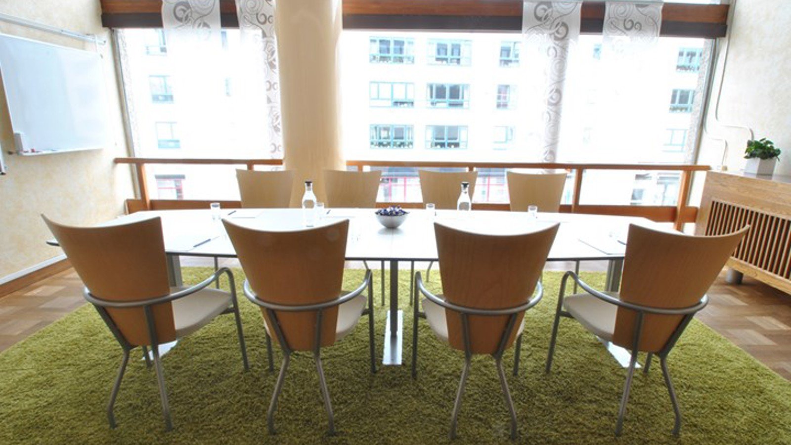 Board room with green carpet and large windows