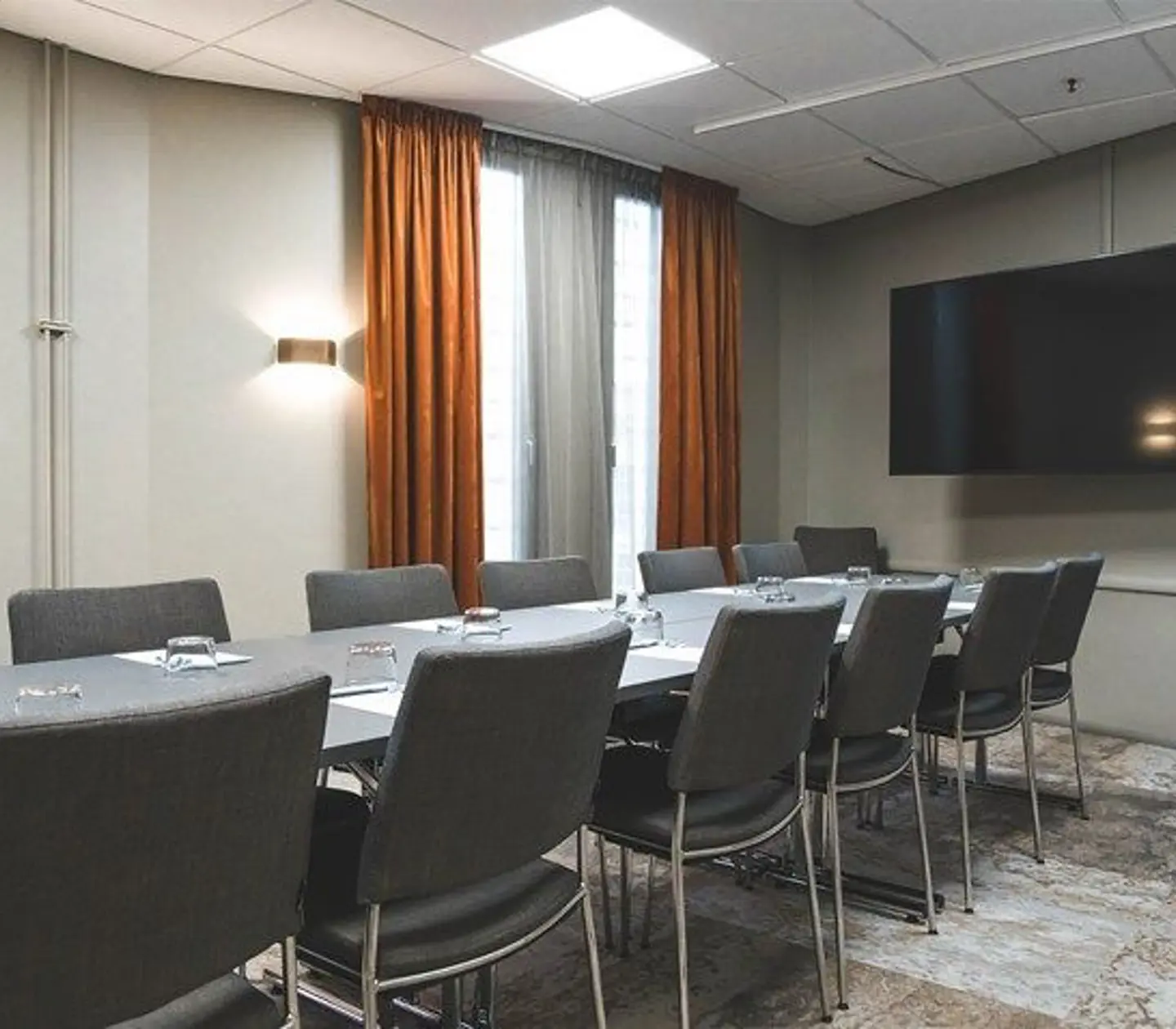 Conference table with pad, pens and glasses
