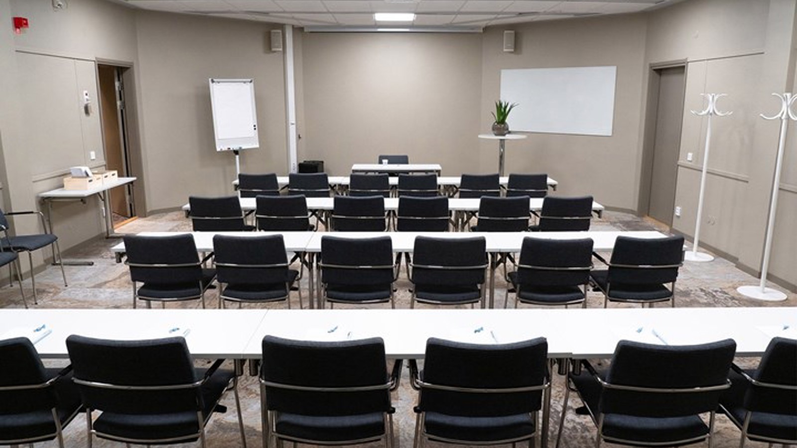 Conference room with lined up chairs and gray walls