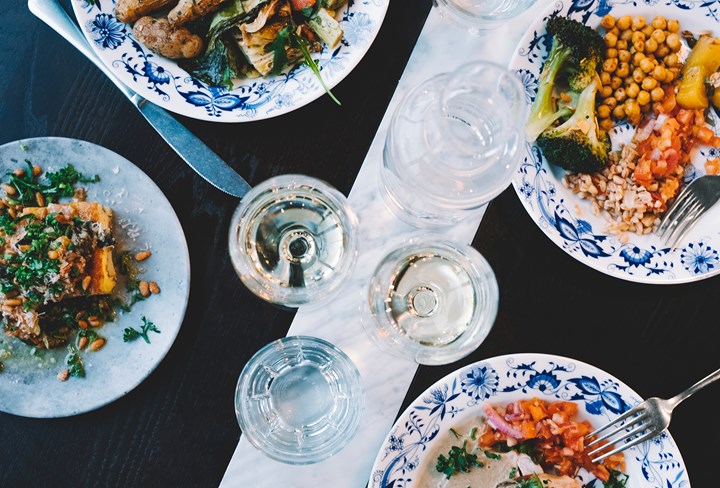 Four plates served with colorful food