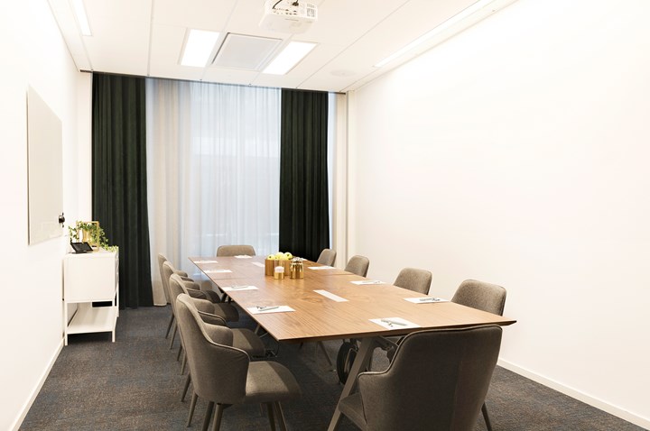 Board room with white walls and gray carpet