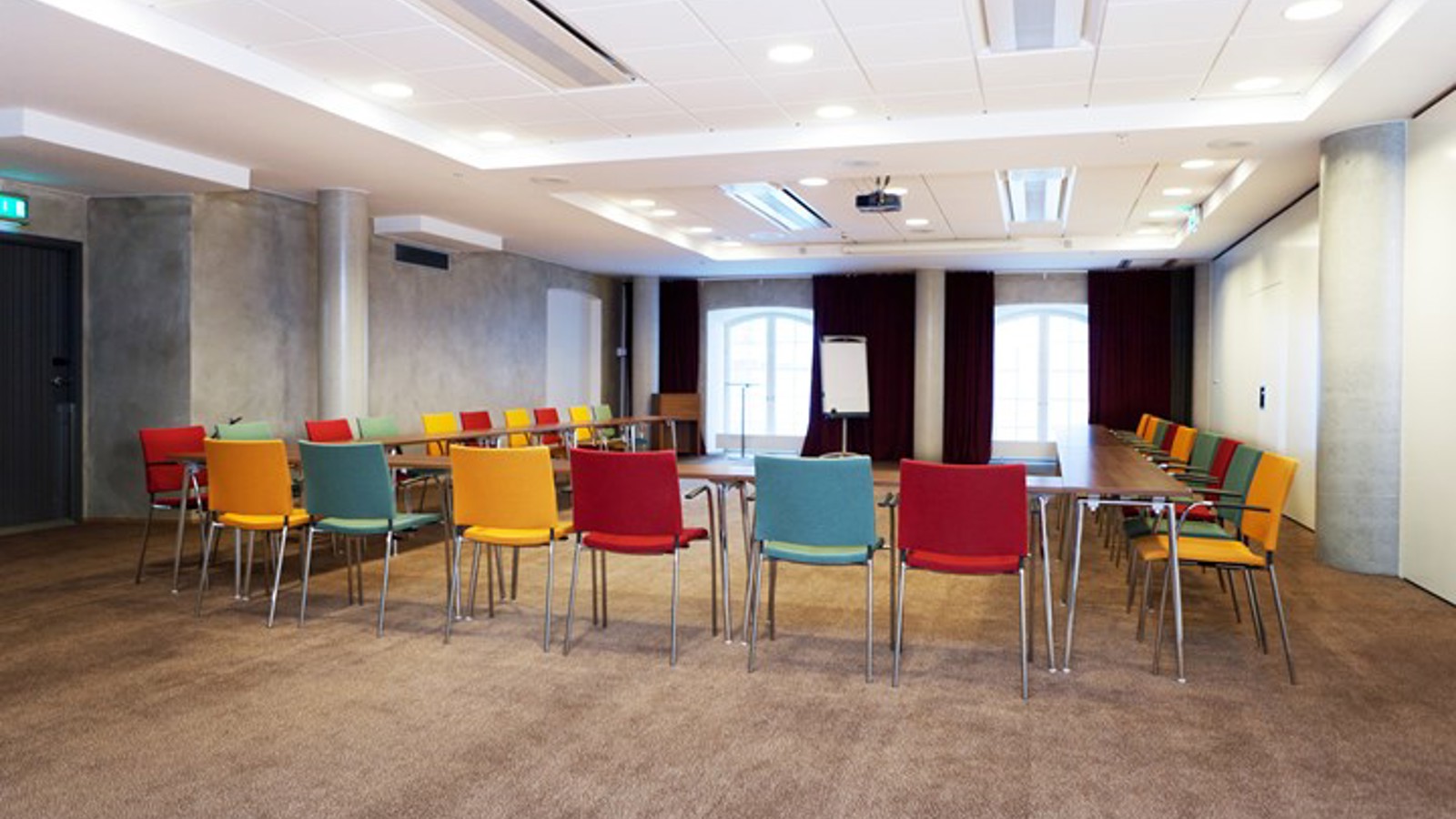 Conference room with u-shaped seating and colorful chairs