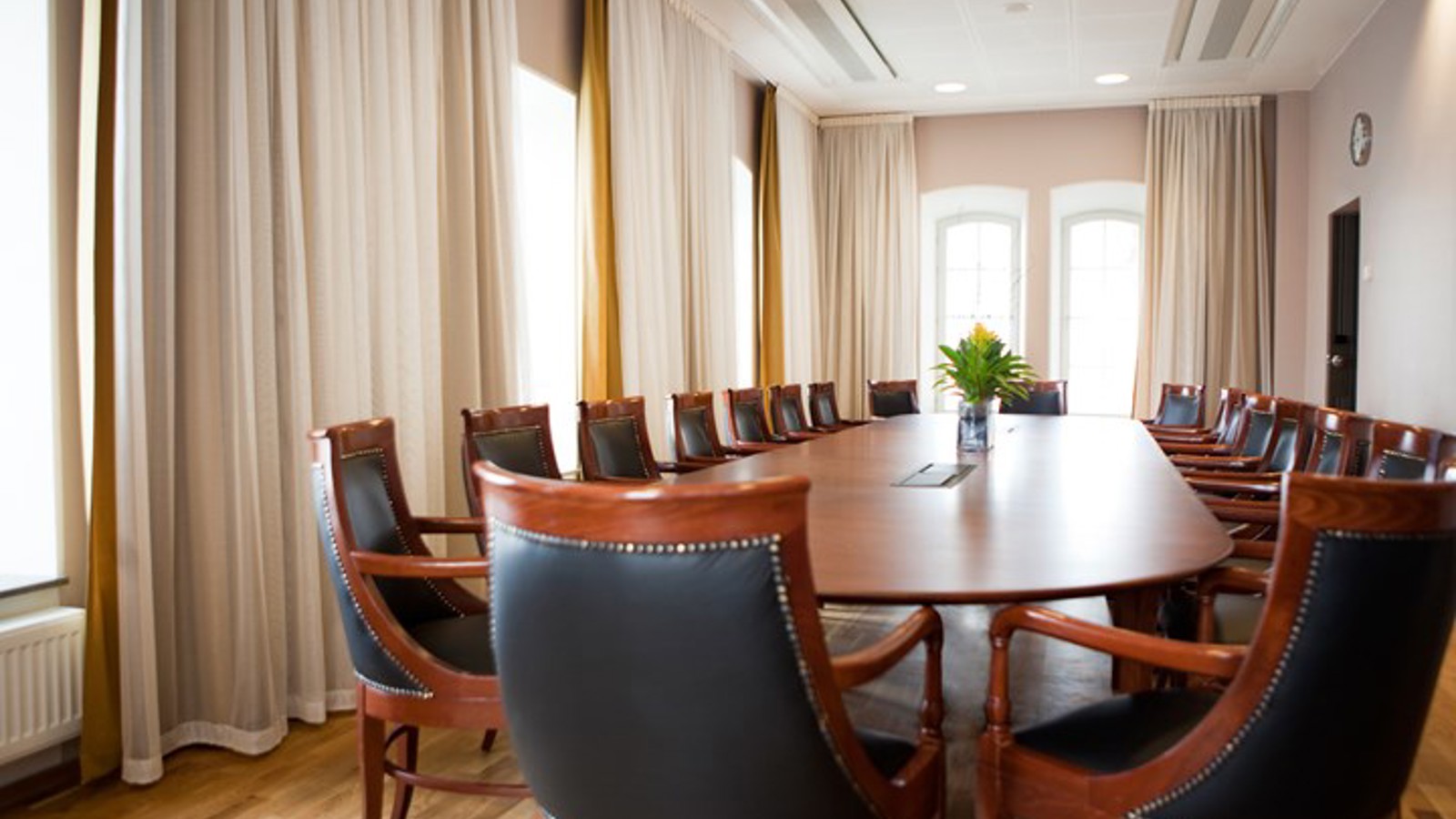 Conference room with board seating, brown table and large windows