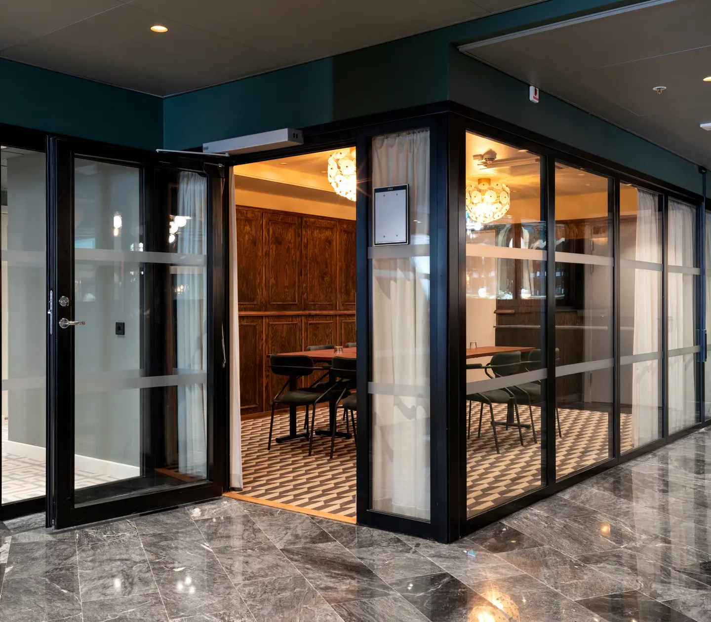 Modern office meeting room with glass doors and luxurious furnishings.