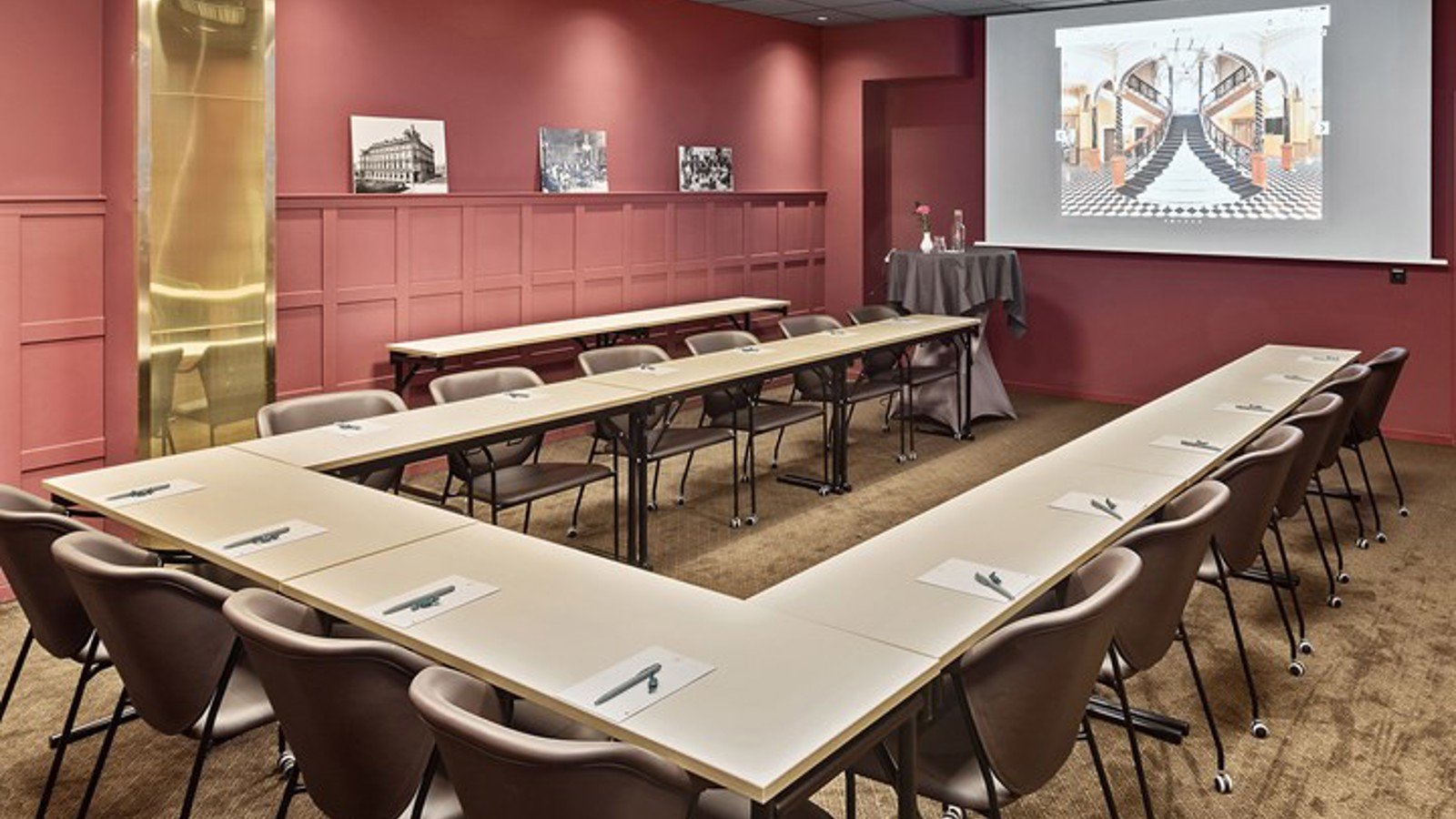 Conference room with U-shaped seating and red walls