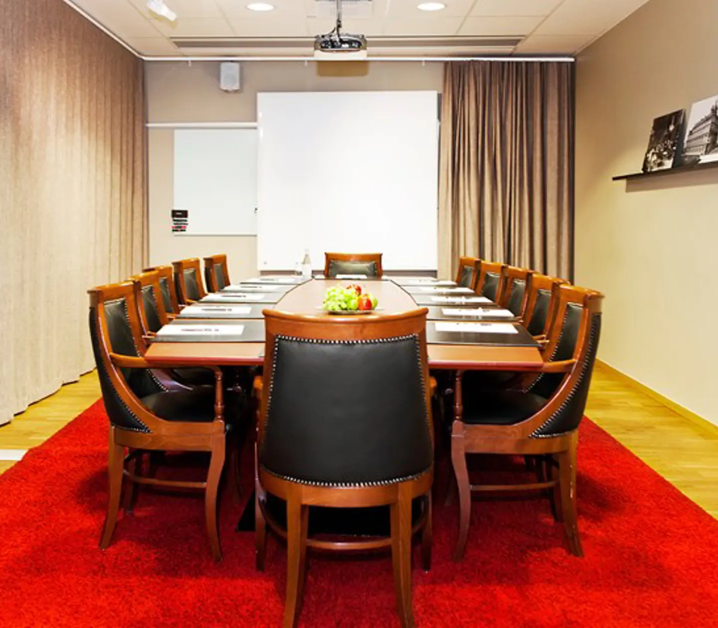 Conference room with board seating, red carpet and wooden furniture