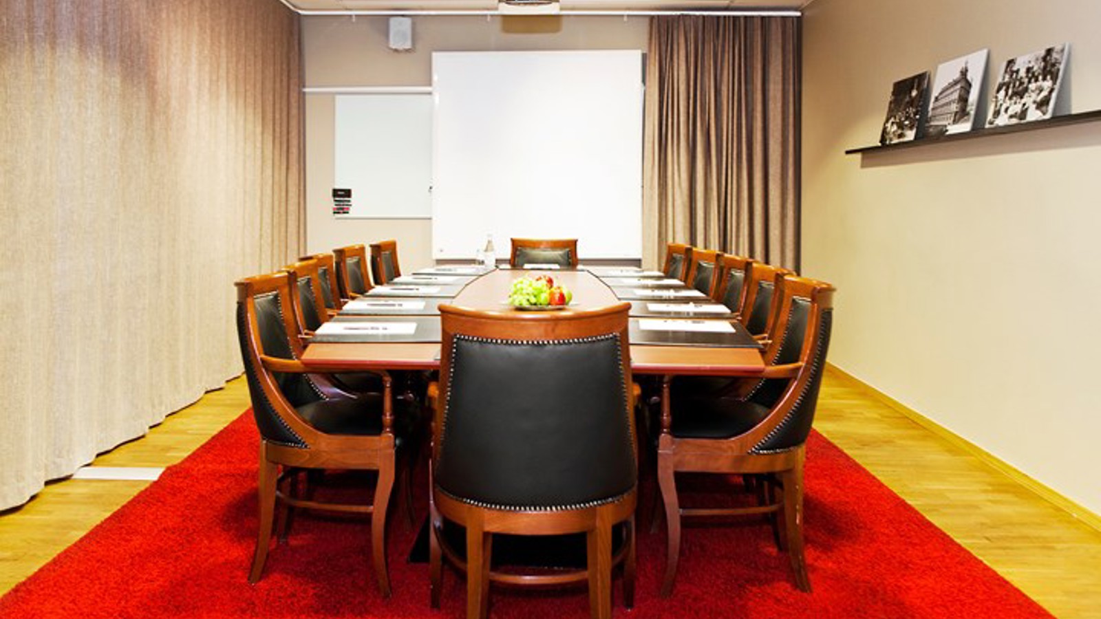 Conference room with board seating, red carpet and wooden furniture