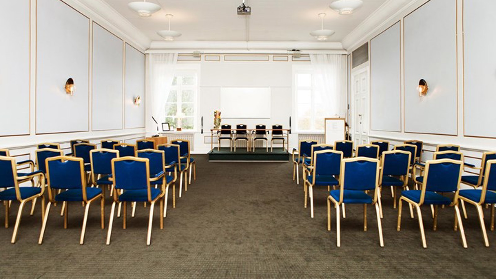 Conference room with cinema seating, light blue walls and blue chairs
