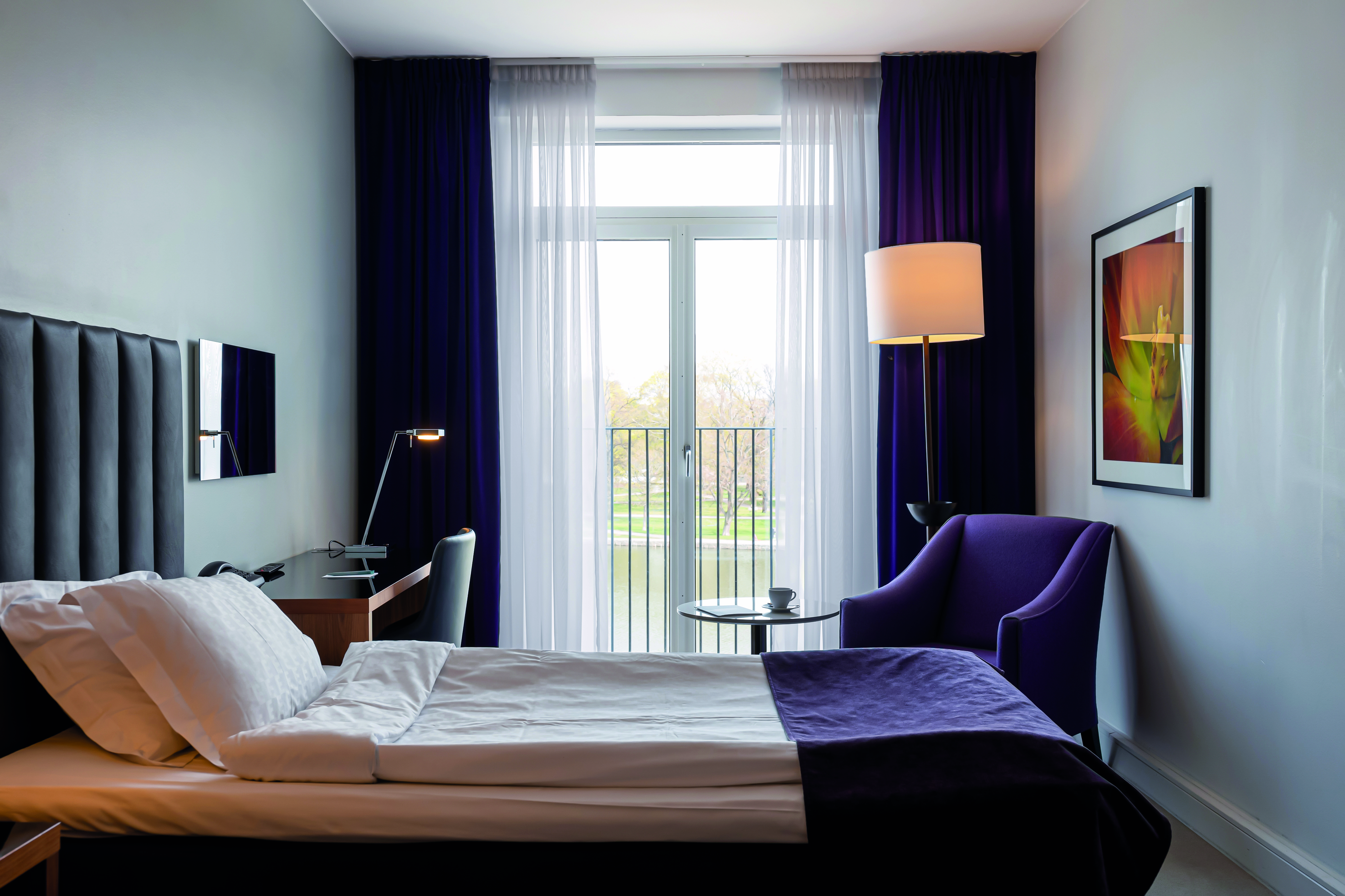 Hotel room with made bed