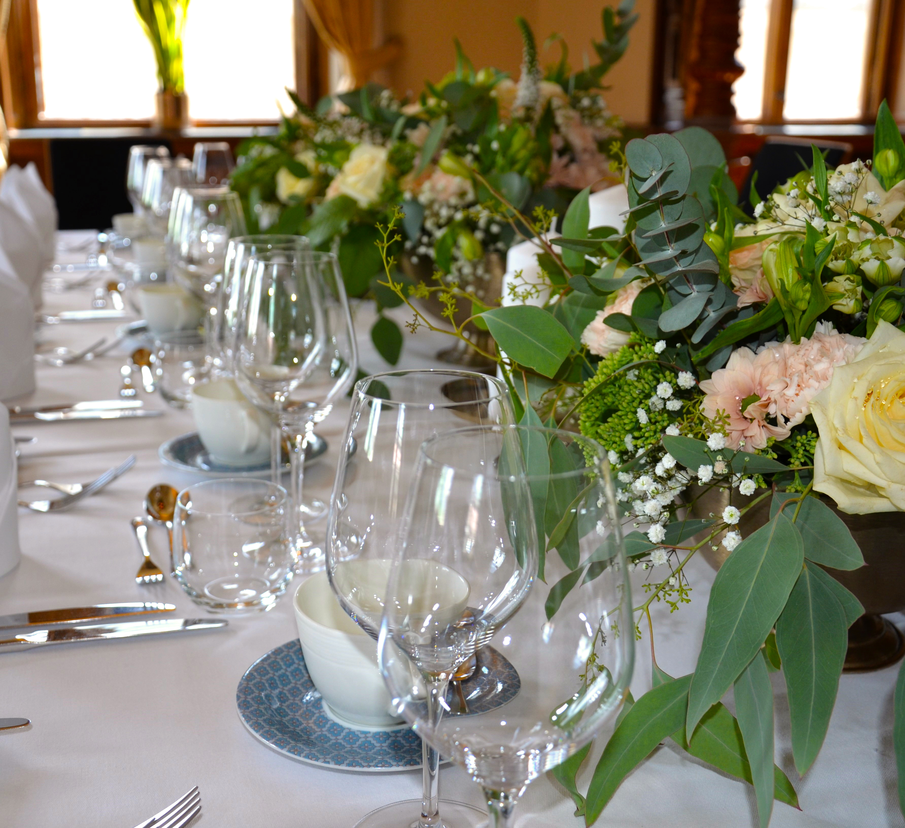 Large wedding venue with several tables and chairs in groups.