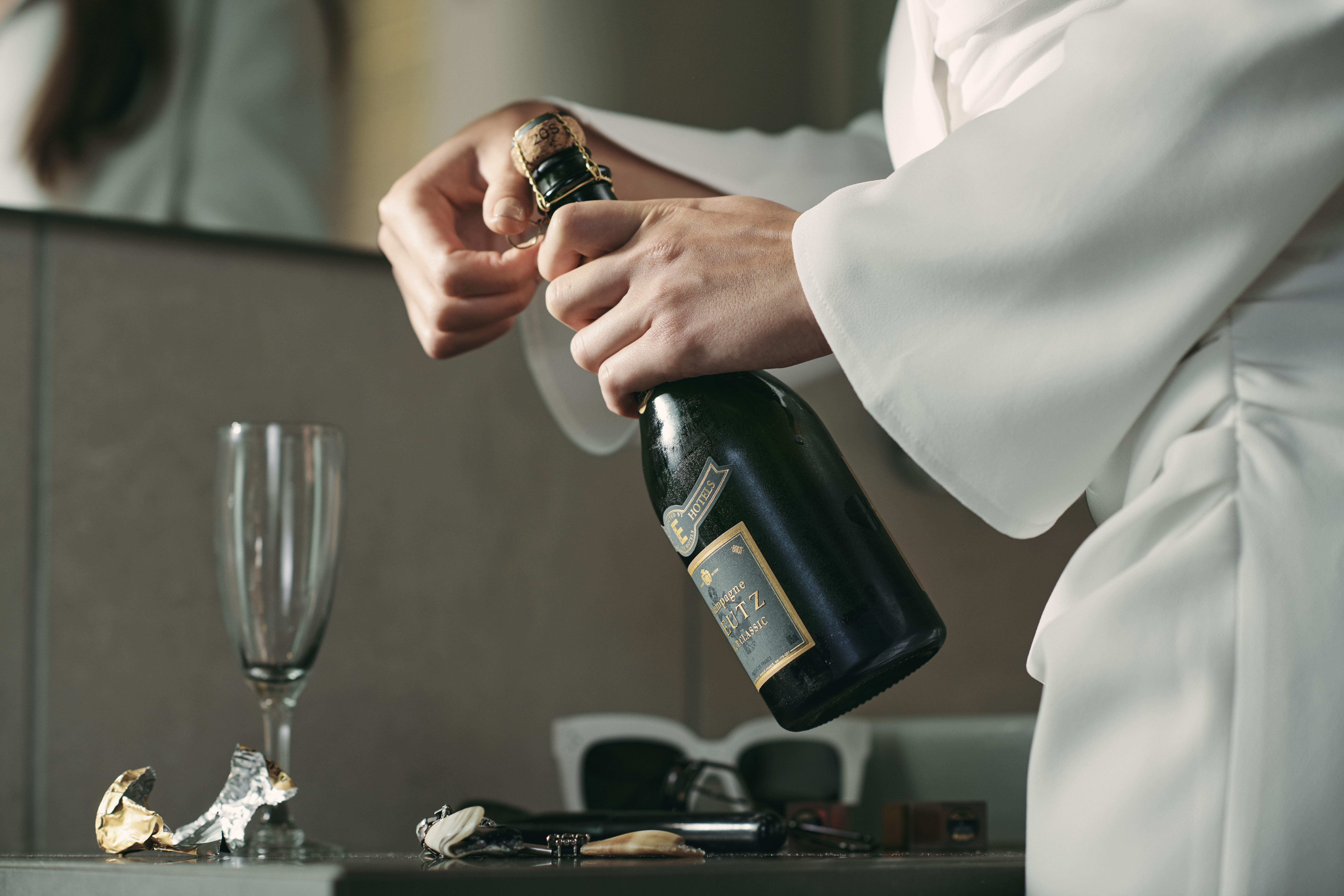 Waiter opens a bottle of champagne