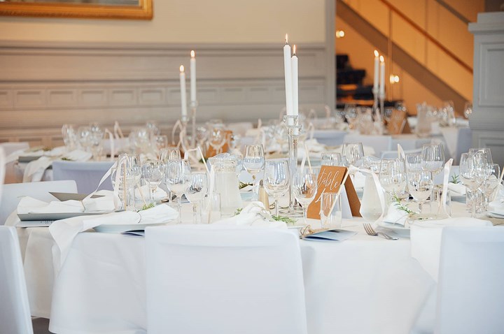 Restaurant table with white tablecloths and beautiful cutlery