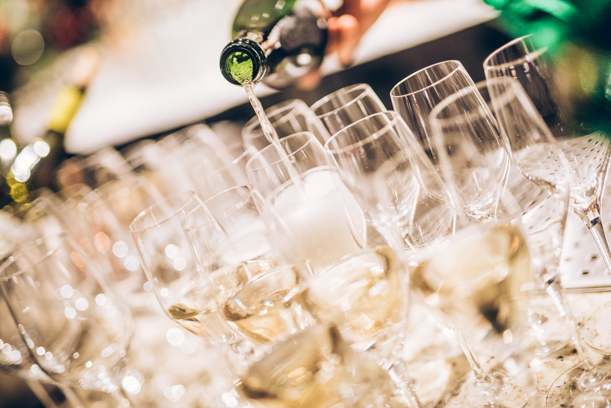 Champagne is being poured into several glasses