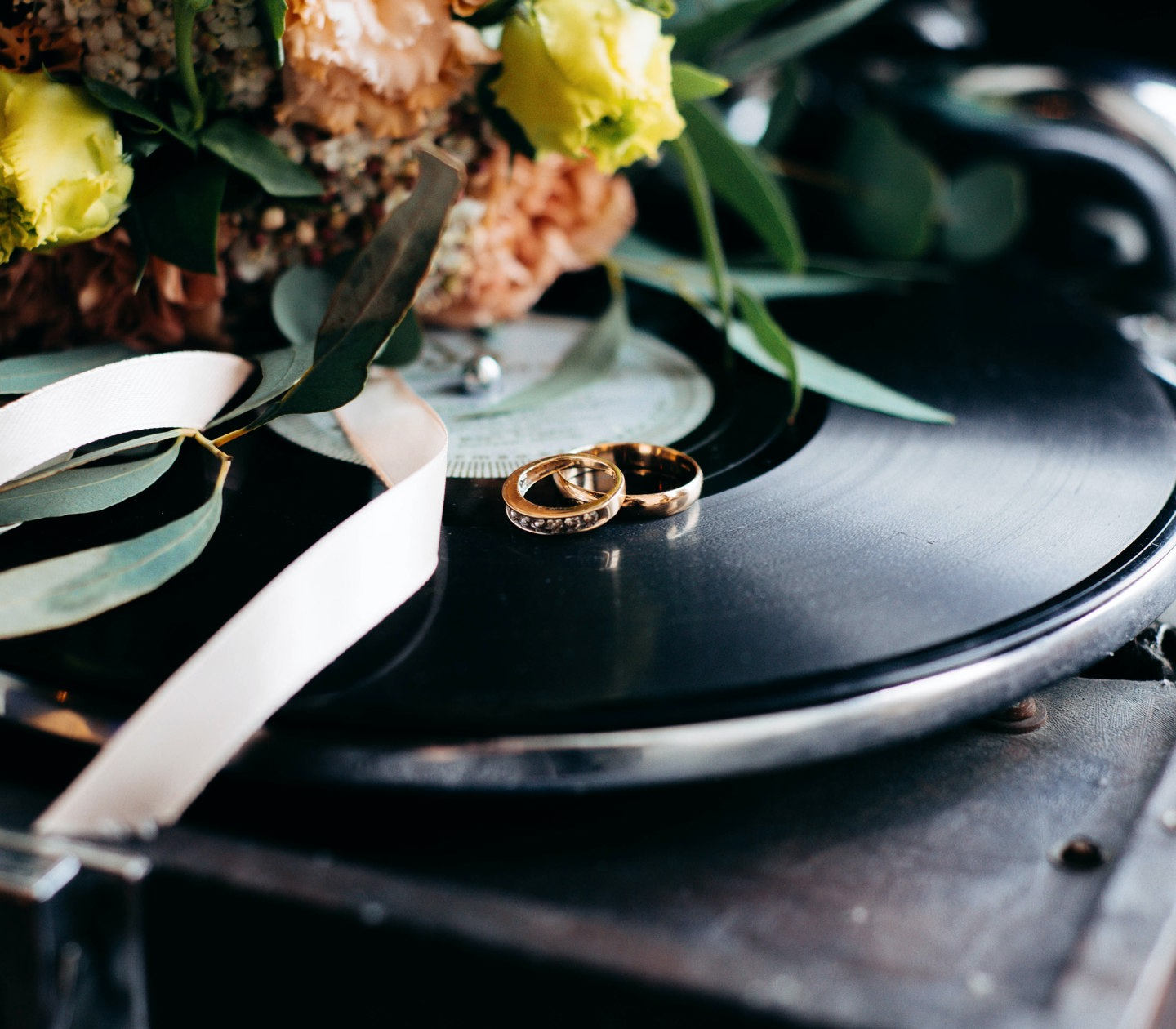 A vinyl player with flowers on top