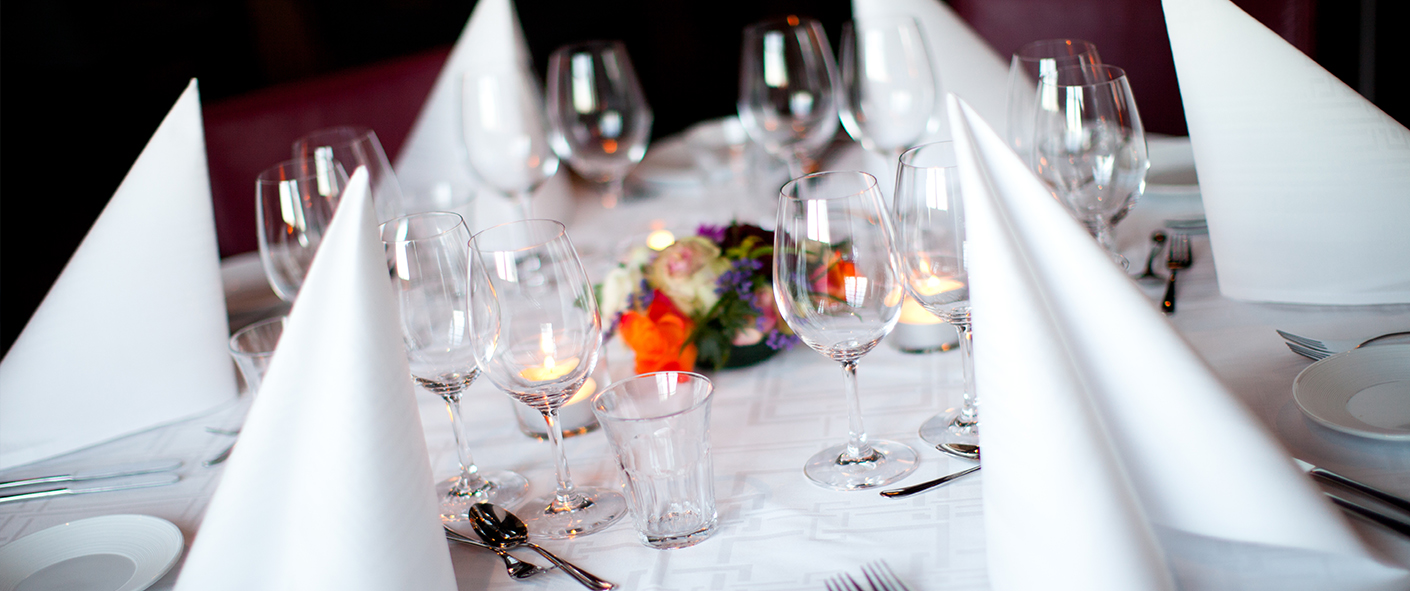 Table in wedding venue decorated with flowers and lit candles