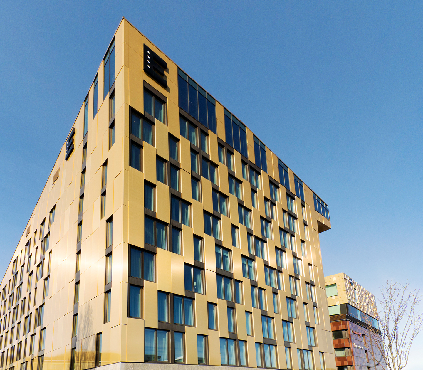 An architect-designed building with a golden facade