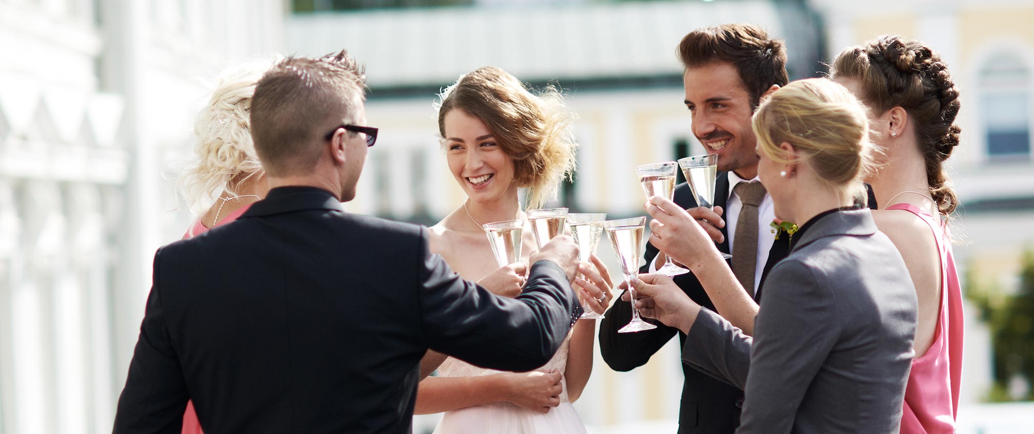 Well dressed people toast with champagne glasses