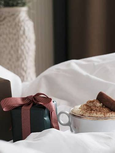 Christmas gifts on a hotel bed