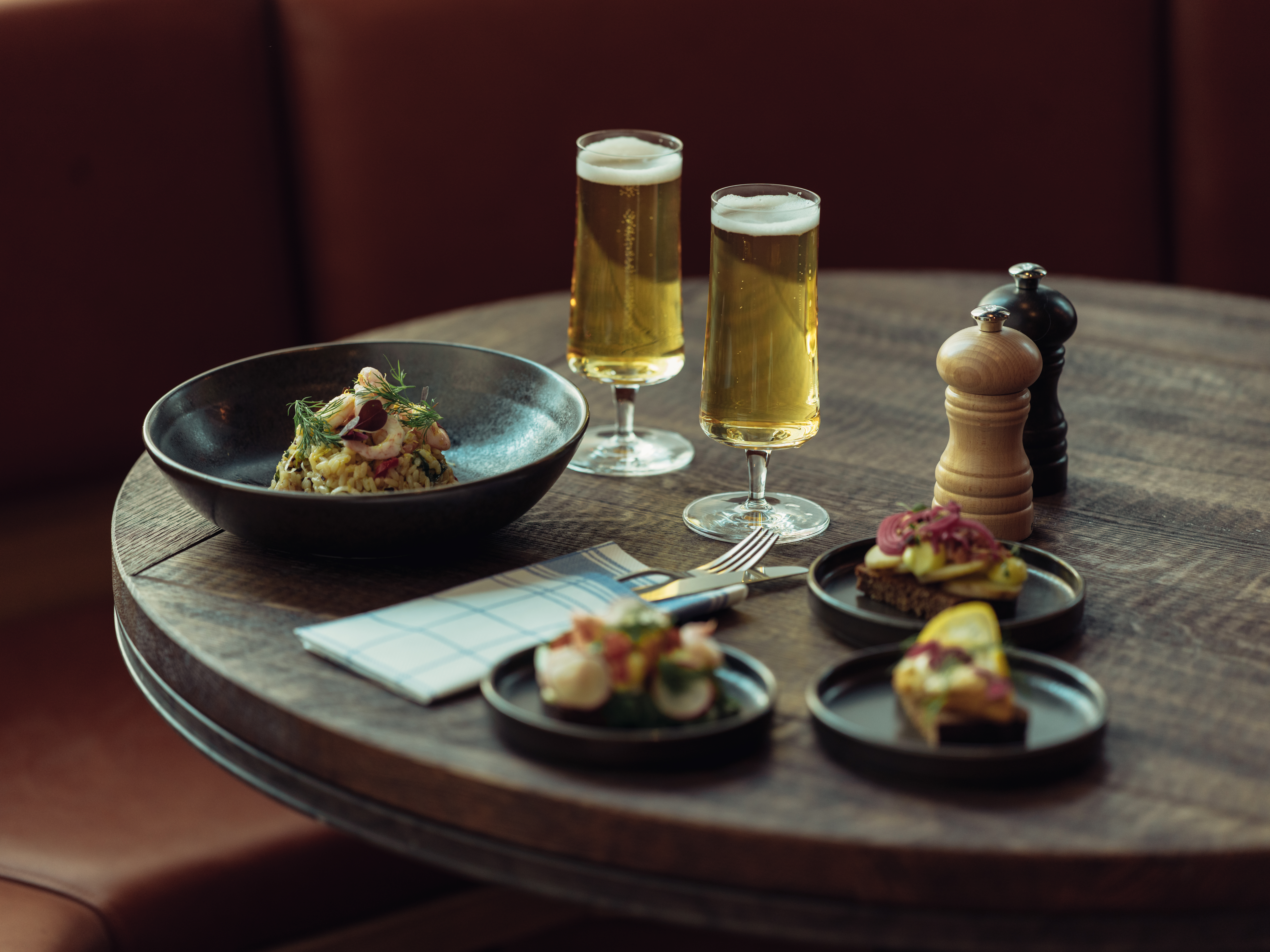 Gourmet appetizers and beer on table