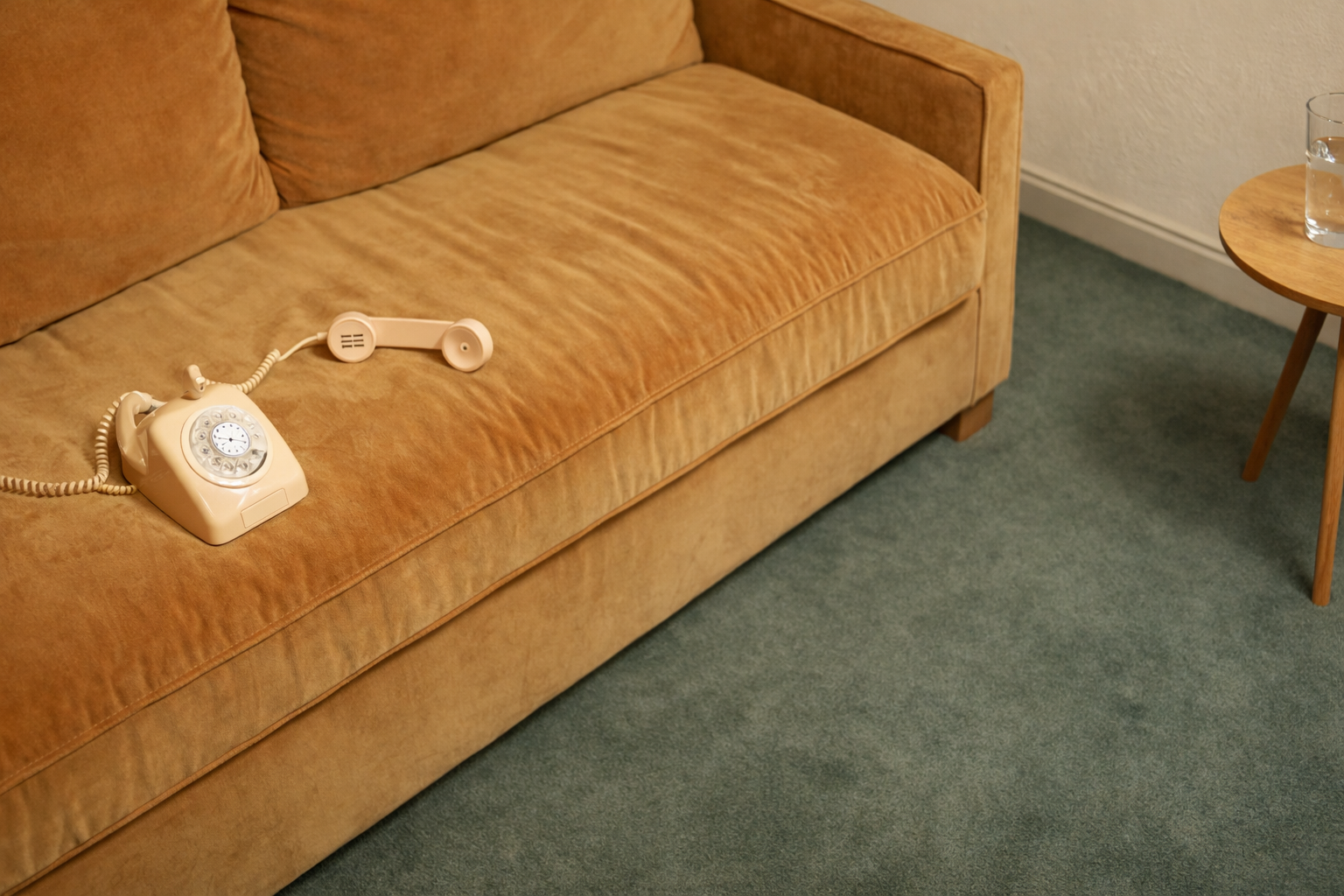 Vintage rotary phone on velvet sofa