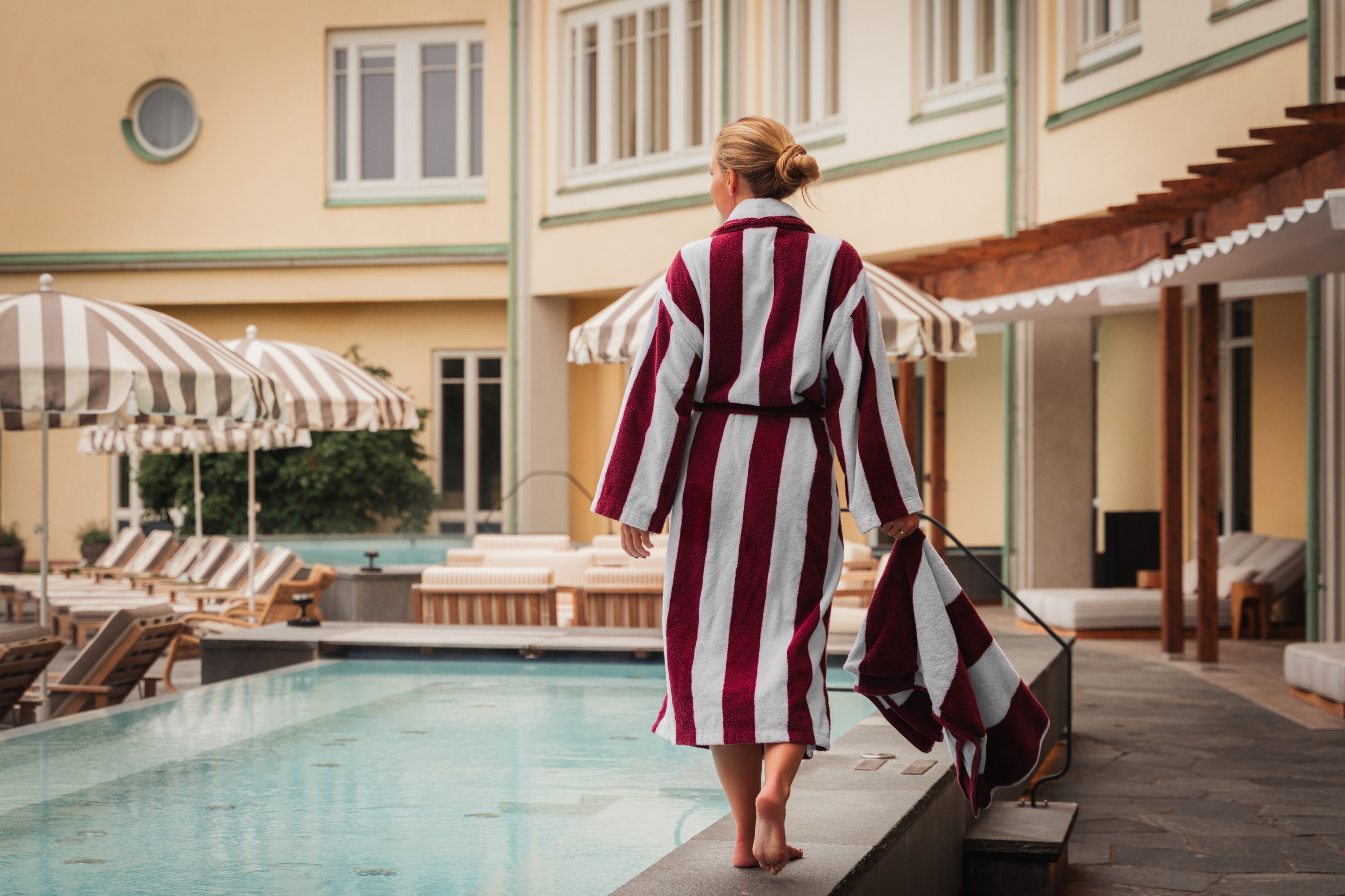 Woman in outdoor pool blocking outwards