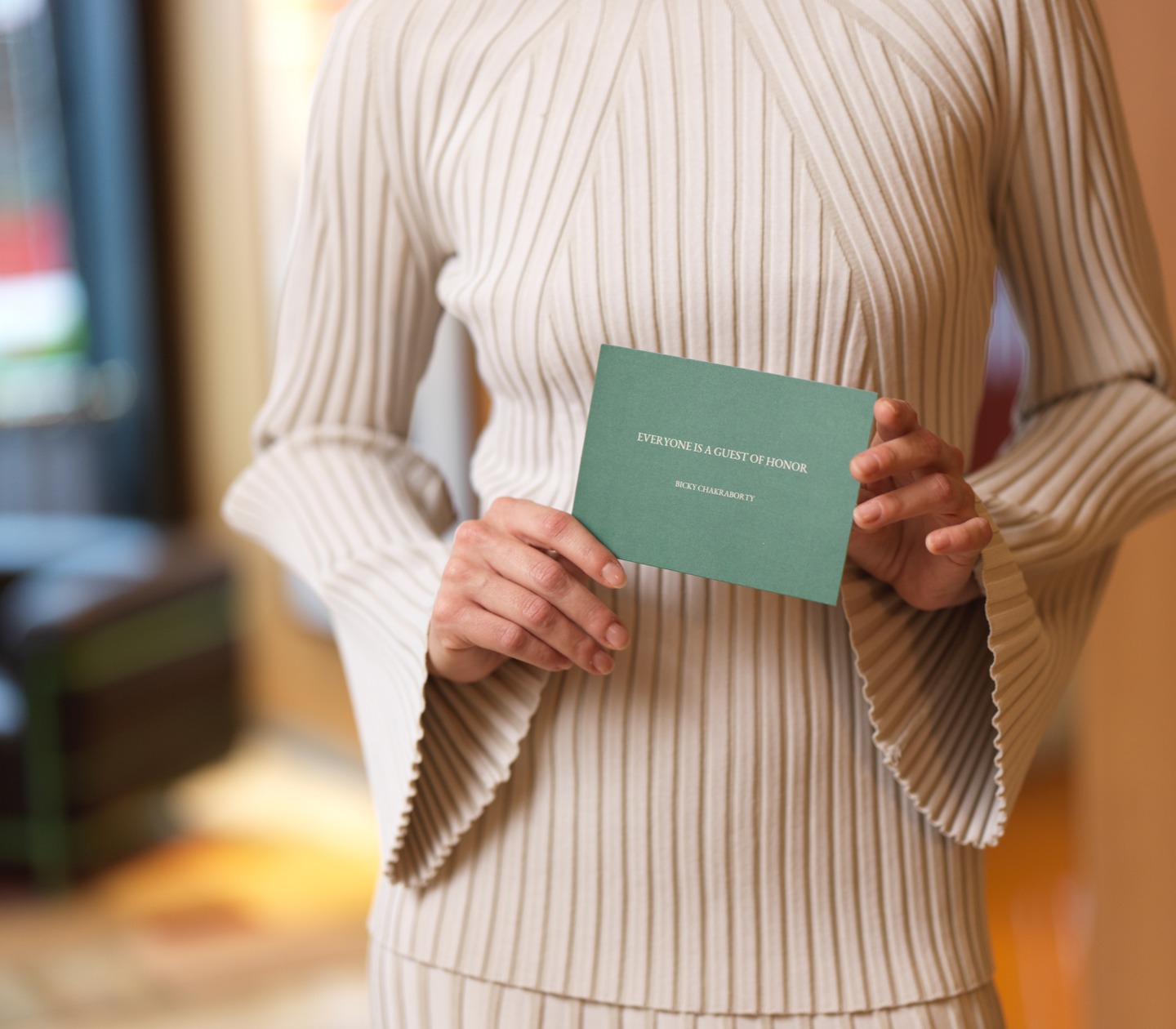 Woman holding green card from Elite Hotels
